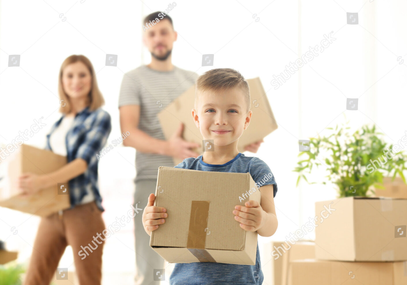 stock-photo-happy-boy-with-box-on-blurred-background-moving-concept-589394252